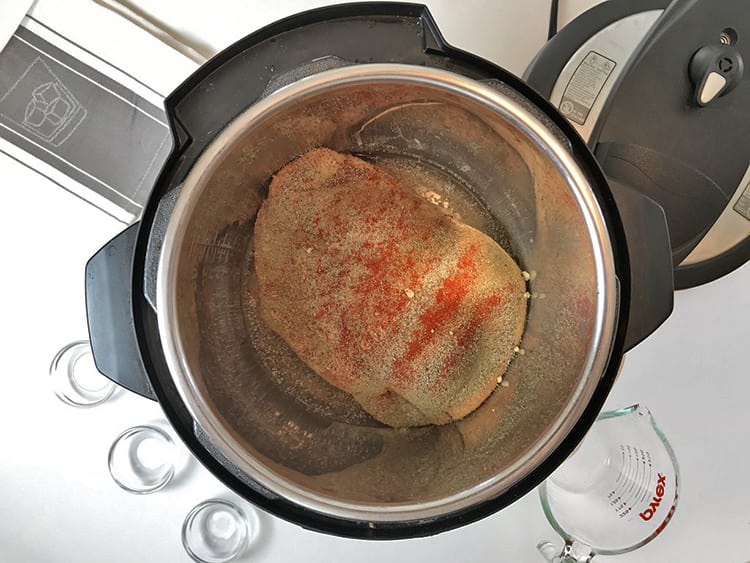 Seasoning the meat for Instant Pot Hot Turkey Sandwiches